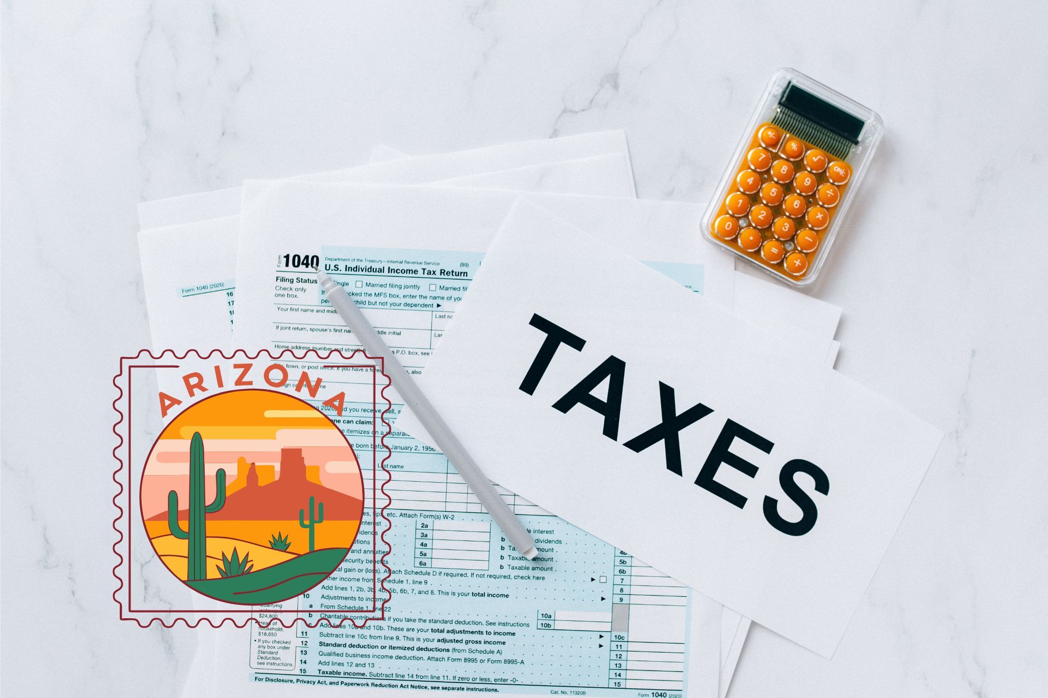 A capital gains calculator sits next to tax forms, a paper with the word 'TAXES', and an Arizona state logo on a white marble surface.