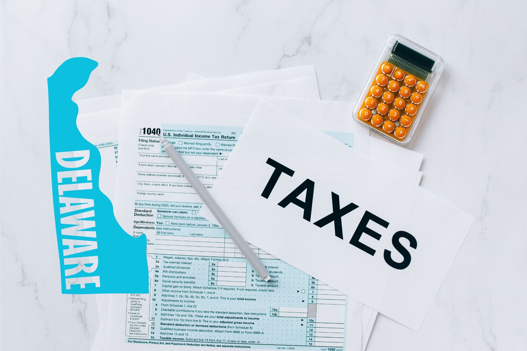 A capital gains calculator sits next to tax forms, a paper with the word 'TAXES', and an Delaware state logo on a white marble surface.