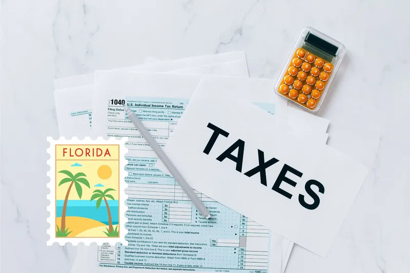 A capital gains calculator sits next to tax forms, a paper with the word 'TAXES', and an Florida state logo on a white marble surface.