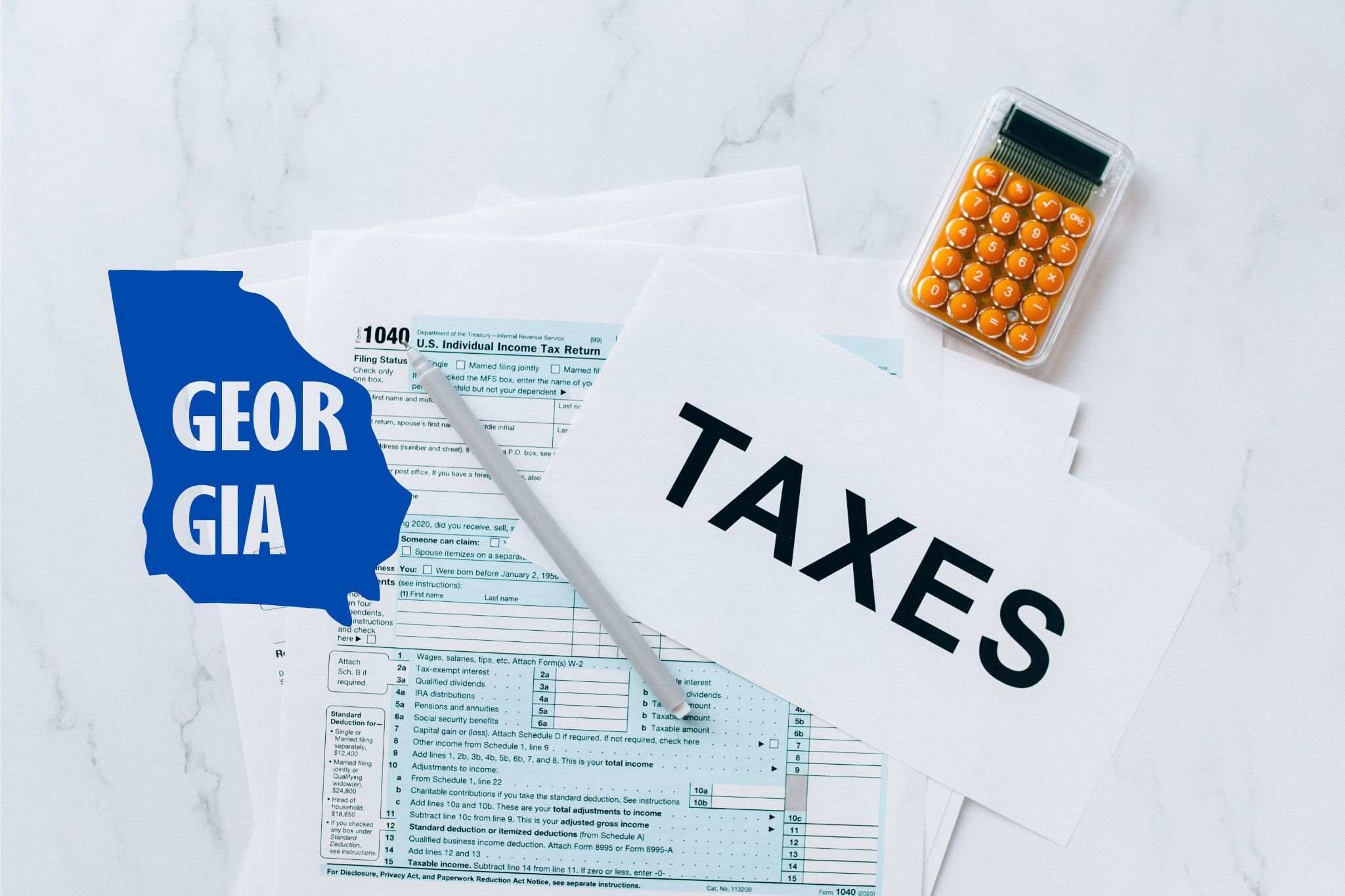 A capital gains calculator sits next to tax forms, a paper with the word 'TAXES', and an Georgia state logo on a white marble surface.