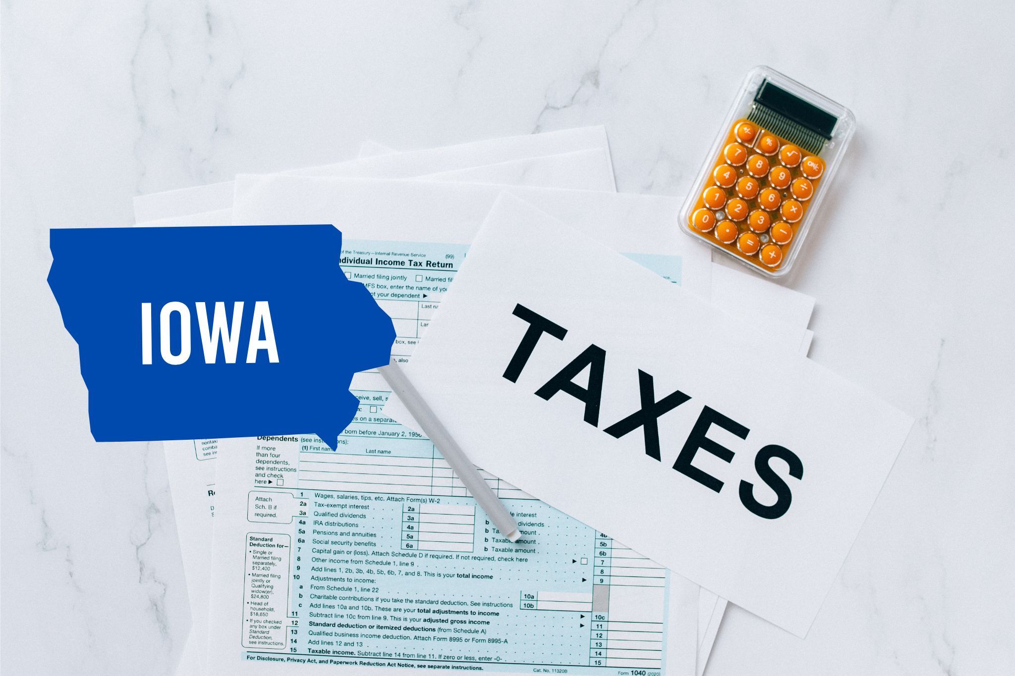 A capital gains calculator sits next to tax forms, a paper with the word 'TAXES', and an Iowa state logo on a white marble surface.
