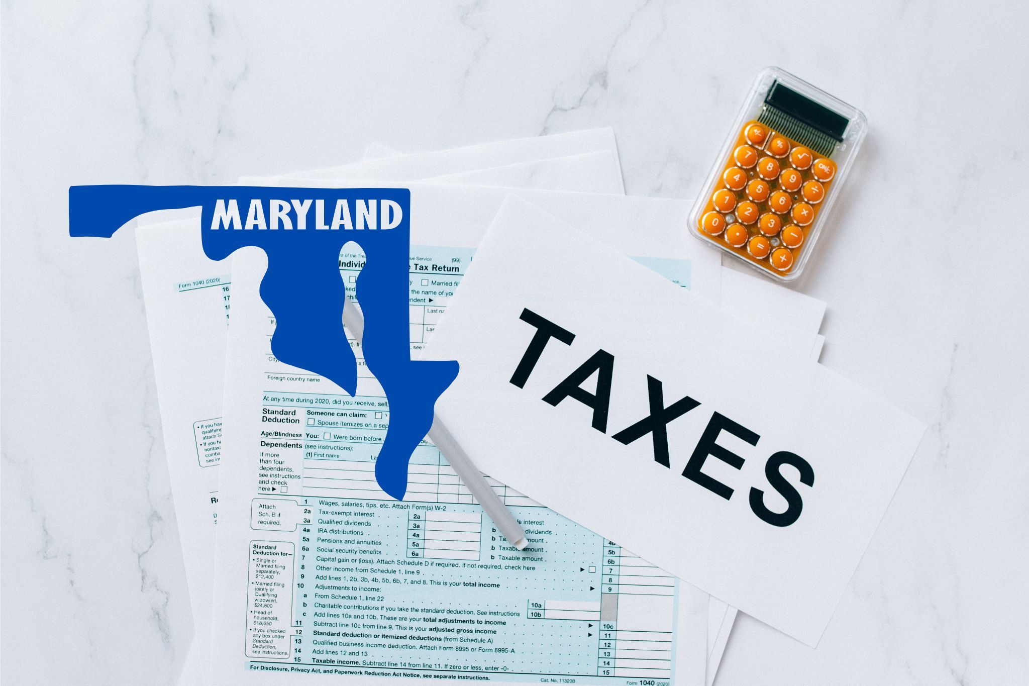 A capital gains calculator sits next to tax forms, a paper with the word 'TAXES', and an Maryland state logo on a white marble surface.