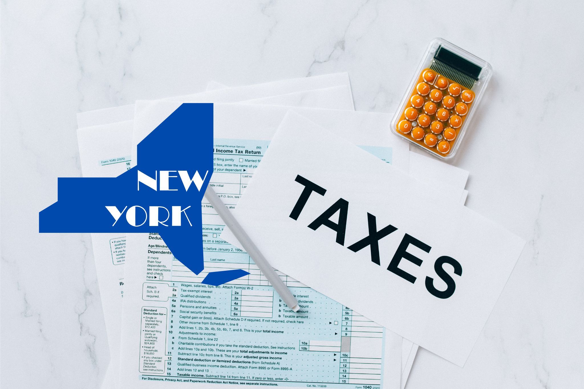 A capital gains calculator sits next to tax forms, a paper with the word 'TAXES', and an New York state logo on a white marble surface.