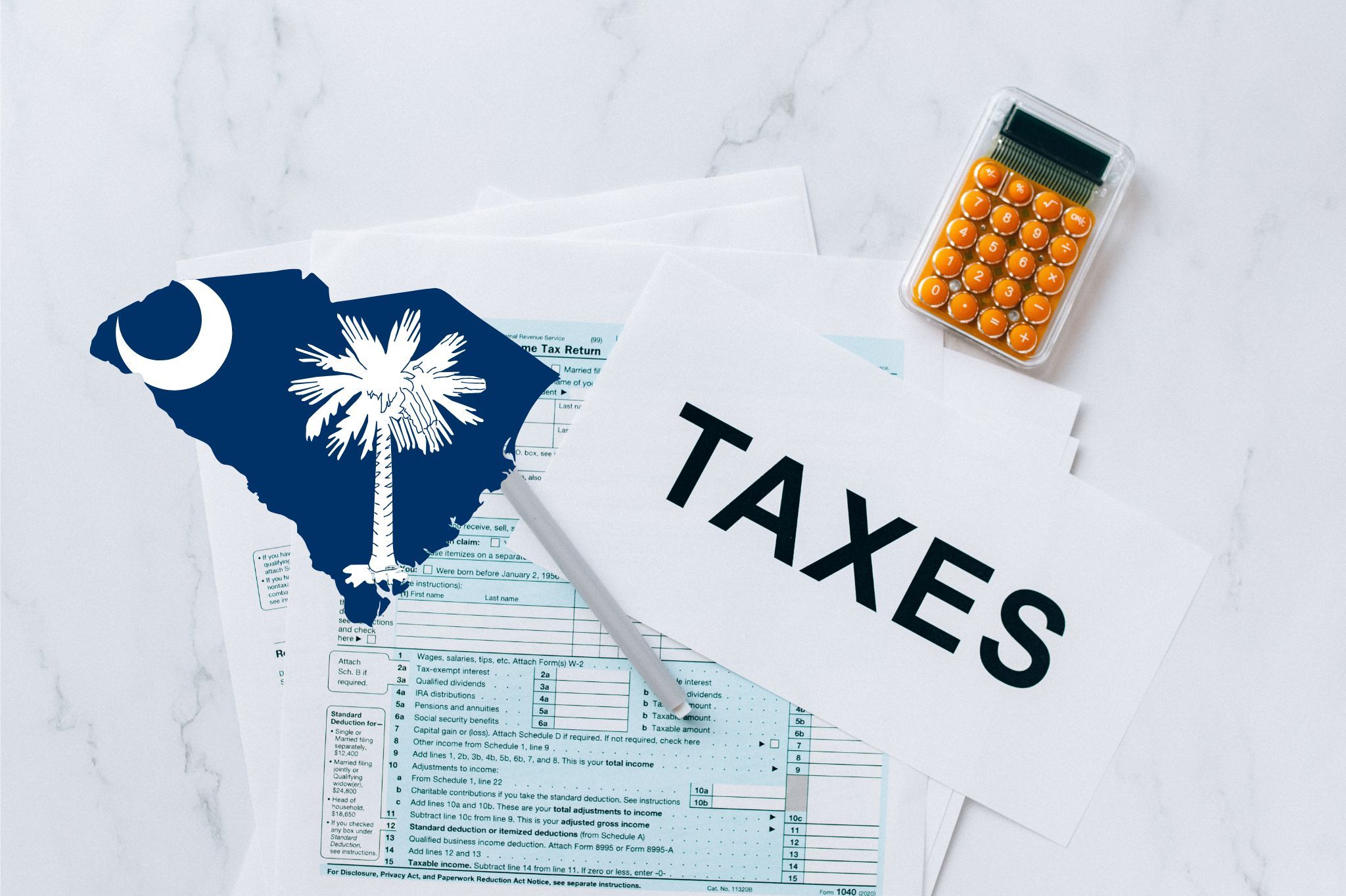 A capital gains calculator sits next to tax forms, a paper with the word 'TAXES', and an South Carolina state logo on a white marble surface.