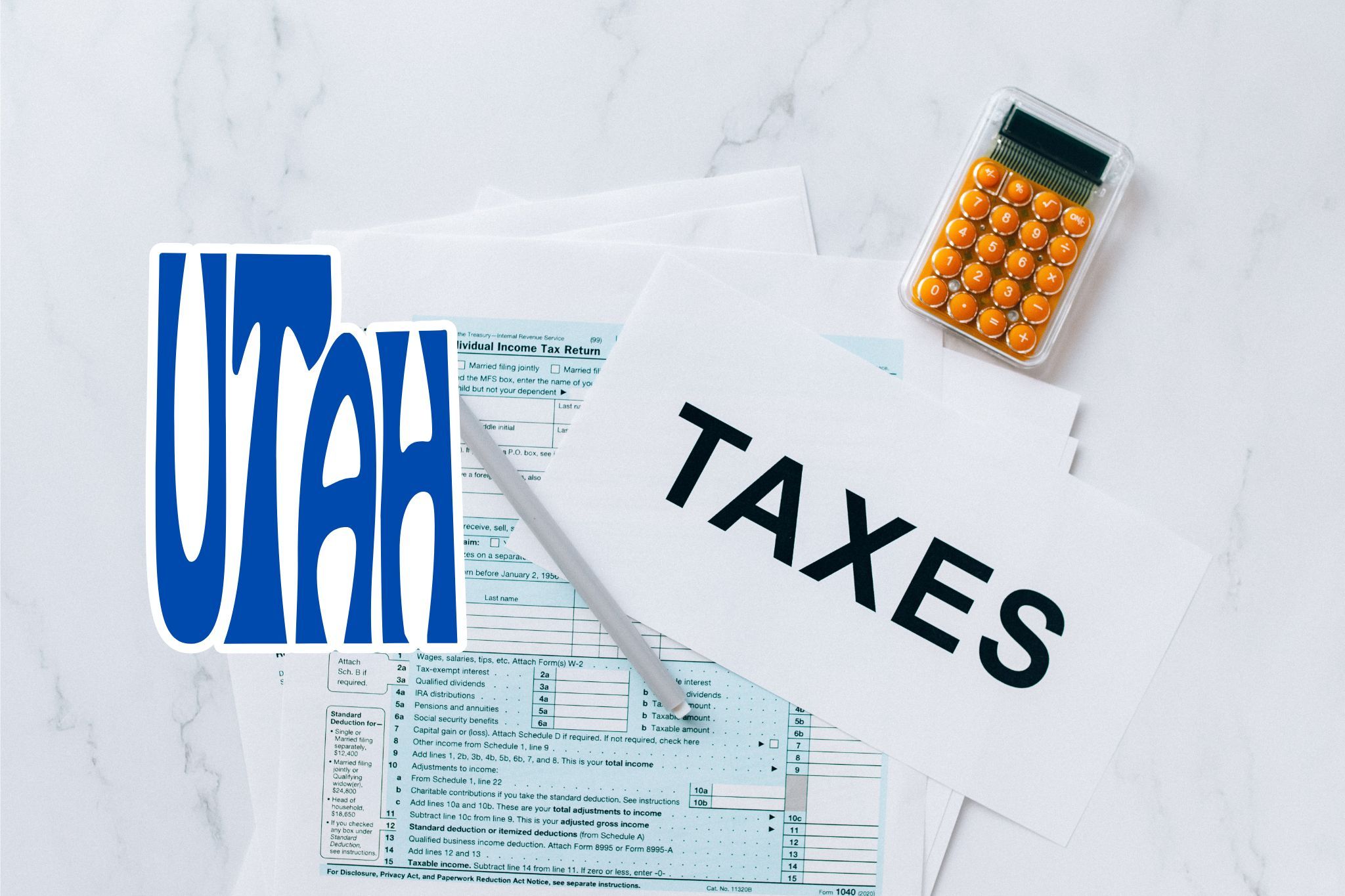 A capital gains calculator sits next to tax forms, a paper with the word 'TAXES', and an Utah state logo on a white marble surface.
