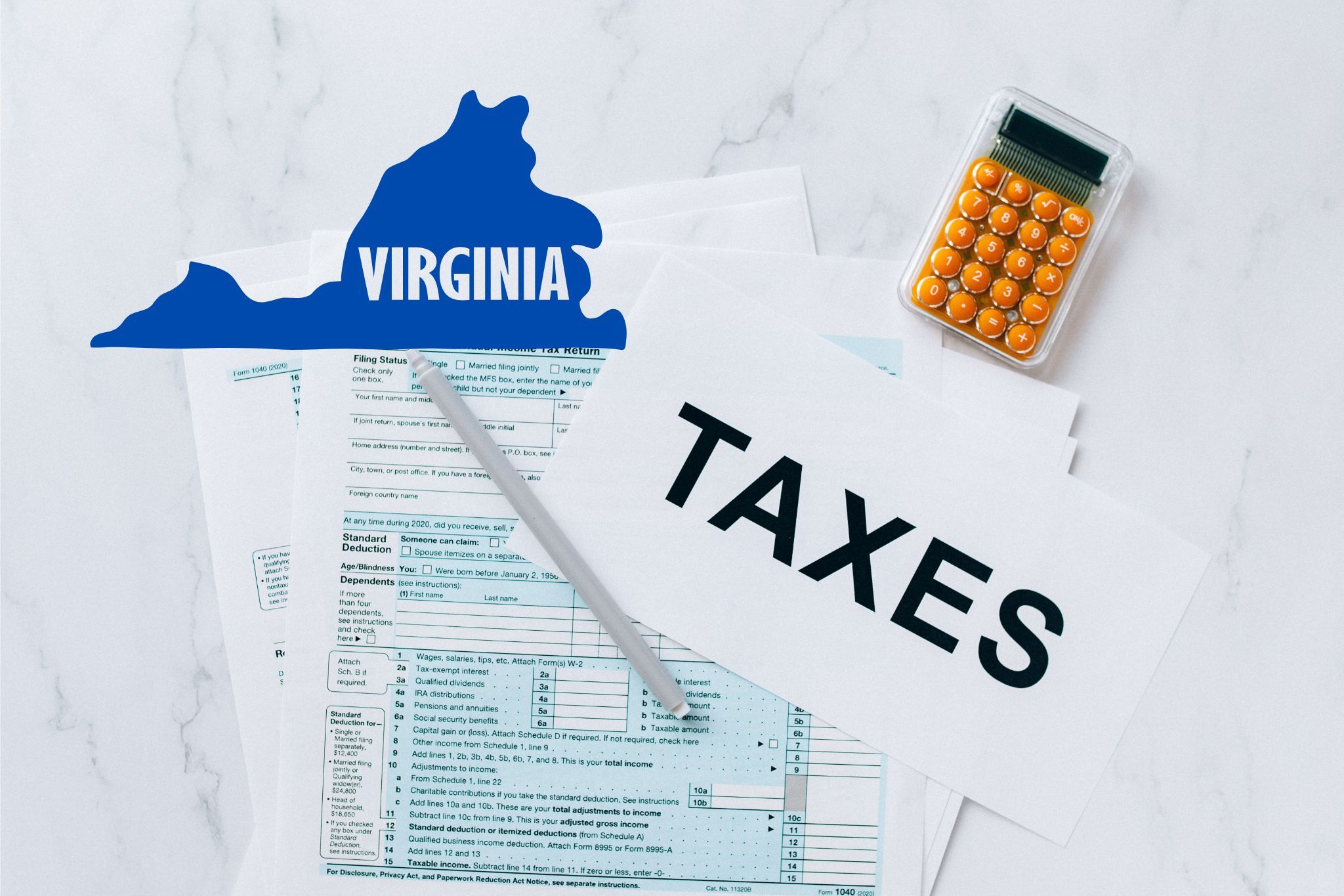 A capital gains calculator sits next to tax forms, a paper with the word 'TAXES', and an Virginia state logo on a white marble surface.