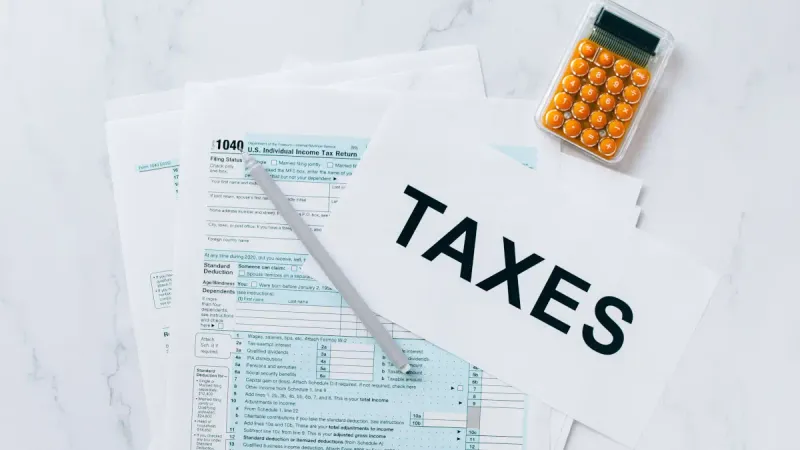 Papers related to taxes with a calculator and text reading Texas